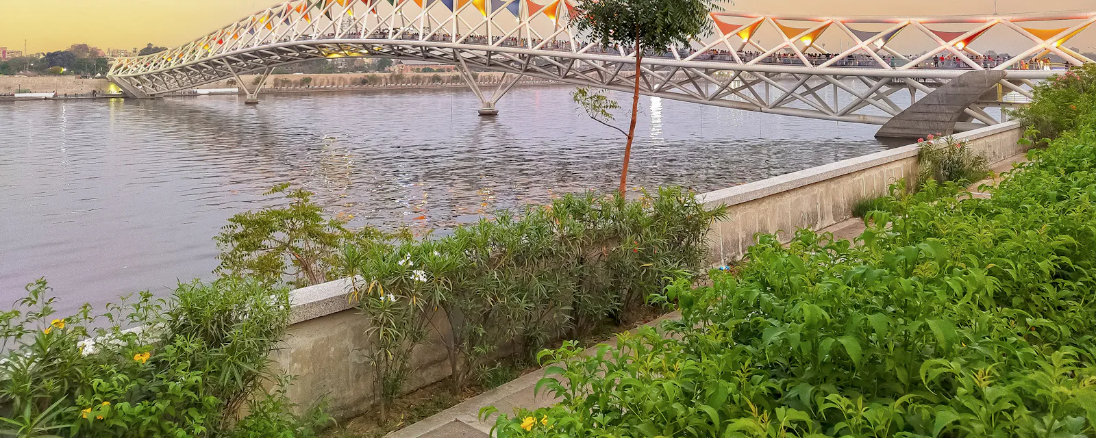 The Sabarmati riverfront garden in Ahmedabad with Atal Bridge in the distance