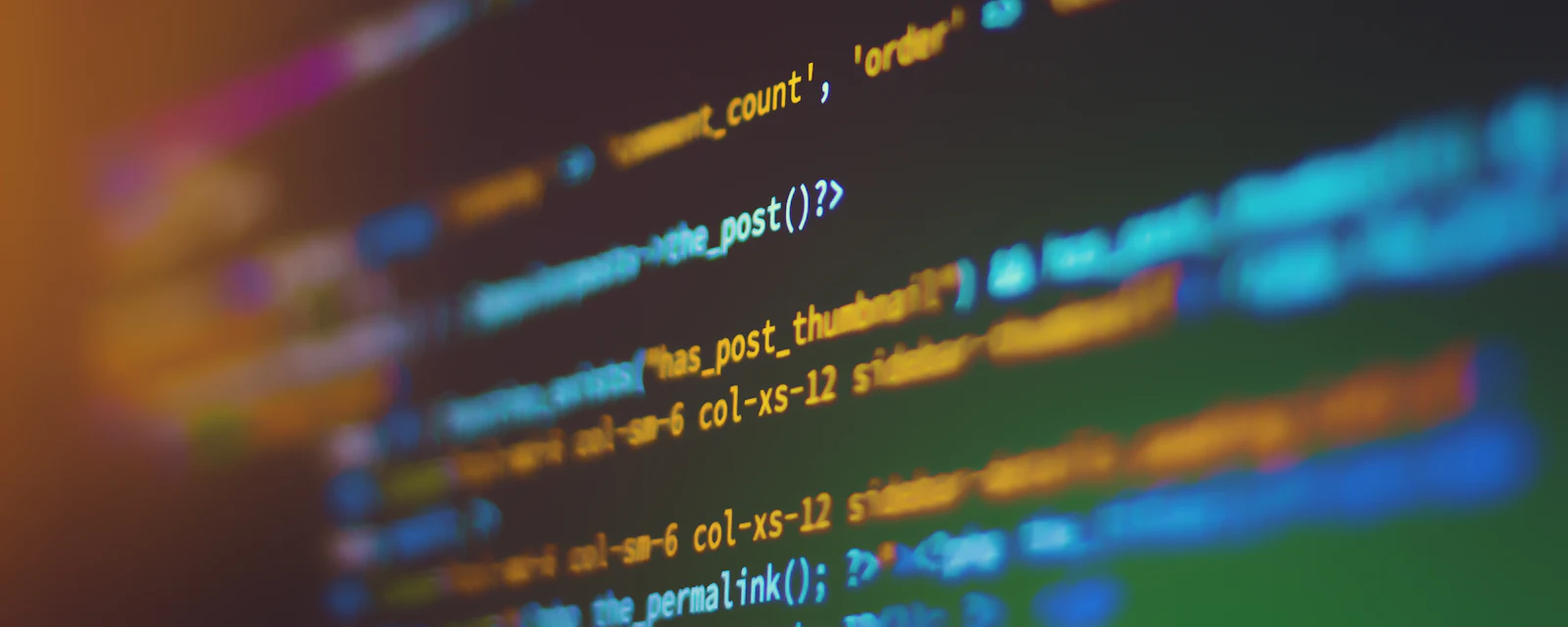 Colourful source code on a screen in shallow focus