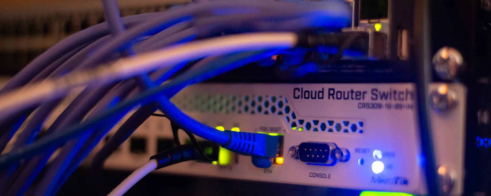 Network equipment with ethernet cables connected, lit in blue